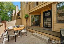 Cozy outdoor patio with dining area, string lights, and convenient access to the home at 5016 Buckingham Rd # 4, Boulder, CO 80301
