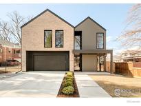 Beautiful two-story home with a modern design, brick accents, and a two-car garage at 633 Dexter St, Denver, CO 80220