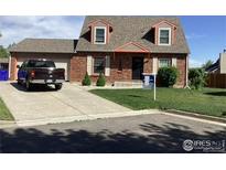 Charming brick home with a well-manicured lawn and inviting curb appeal at 719 Marshall Pl, Berthoud, CO 80513