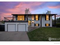 Stylish two-story home featuring a two-car garage, balcony, and modern black and white design at 794 W Elati W Cir, Littleton, CO 80120