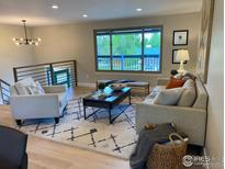 Bright living room with modern decor, large window, and cozy seating arrangement at 794 W Elati W Cir, Littleton, CO 80120