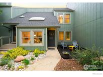 Charming townhome with a cozy front patio, lush landscaping, and a welcoming entrance at 93 Benthaven Pl, Boulder, CO 80305