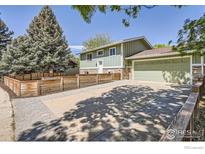 Inviting two-story home with a spacious driveway and a charming wood fence at 1085 Malory St, Lafayette, CO 80026