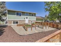 Charming home with a well-manicured front yard and raised garden beds, offering curb appeal at 1085 Malory St, Lafayette, CO 80026