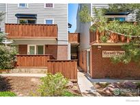 Charming condo building with wood balconies and landscaped grounds, perfect for a cozy living experience at 1111 Maxwell Ave # 122, Boulder, CO 80304