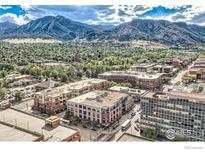 Wonderful aerial view of the city showcasing a mix of residential and commercial properties against a mountain backdrop at 1360 Walnut St # 202, Boulder, CO 80302