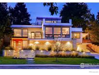 Stunning modern home with beautiful stone accents, professional landscaping, and striking architectural details at 1445 Moss Rock Pl, Boulder, CO 80304