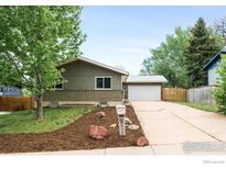 Charming single-story home with a well-maintained lawn and attached garage at 1560 Kendall Dr, Boulder, CO 80305