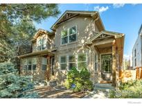 Inviting two-story home with stone accents, manicured landscaping, and a covered front porch at 2055 S Columbine St, Denver, CO 80210