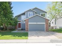Charming two-story home with a well-manicured lawn and a two-car garage at 2935 Bow Line Pl, Longmont, CO 80503