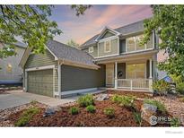 Charming two-story home featuring an attached garage, landscaped front yard, and inviting front porch at 3093 Red Deer Trl, Lafayette, CO 80026