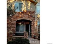Charming stone archway leads to the front entrance of this well-maintained townhome at 457 Black Feather Loop # 704, Castle Rock, CO 80104