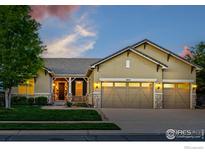 Charming home boasts a three-car garage, well-manicured lawn, and stone accents at 4648 Belford Cir, Broomfield, CO 80023