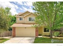 Charming two-story home with attached two-car garage, front porch, and landscaped yard at 4860 W 125Th Ave, Broomfield, CO 80020