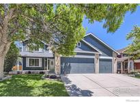 Charming two-story home featuring a three-car garage and a well-manicured front lawn at 5491 E 117Th Ave, Thornton, CO 80233