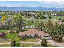 Ranch style home with mountain views and beautiful landscaping and mature trees at 5557 Aspen Ave, Erie, CO 80516