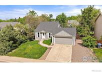 Charming single-Gathering home with a well-maintained lawn, mature trees and a two-car garage at 904 Clover Cir, Lafayette, CO 80026
