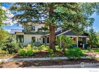 Charming two-story home with landscaped yard and a welcoming front porch at 908 Rex St, Louisville, CO 80027
