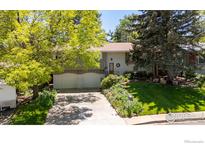 Charming home with mature trees, landscaped yard, and a two-car garage at 1560 Findlay Way, Boulder, CO 80305