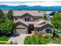 Charming two-story home with well-manicured lawn, two-car garage, and stunning mountain views at 16069 Pikes Peak Dr, Broomfield, CO 80023
