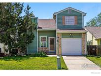 Charming two-story home with well-maintained lawn and classic architectural details at 1817 Juniper St, Longmont, CO 80501