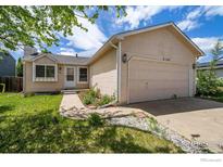 Charming single Gathering home with a well-maintained lawn, two car garage, and cozy front porch at 2167 Hackberry Cir, Longmont, CO 80501