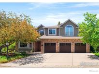 Stunning two-story home with brick accents, arched windows, and a spacious three-car garage at 2345 Spotswood Pl, Boulder, CO 80304