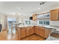 Bright eat-in kitchen features granite countertops and stainless steel appliances at 24285 E Wagontrail Ave, Aurora, CO 80016