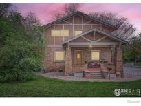 Charming two-story home with brick and stucco exterior and inviting front porch at 3116 47Th St, Boulder, CO 80301