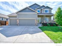 Charming two-story home featuring a three car garage and a welcoming covered front porch at 9018 Harlequin Cir, Frederick, CO 80504
