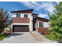 Modern two-story home featuring a two-car garage, contemporary design, and a well-maintained front yard at 10069 Richfield St, Commerce City, CO 80022