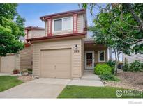 Inviting home featuring a one-car garage, cozy porch, and well-maintained lawn in a desirable neighborhood at 109 Huntley Creek Ct, Erie, CO 80516