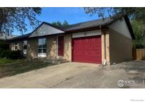 Charming one-story home with brick facade and red door and garage at 12820 Dexter St, Thornton, CO 80241
