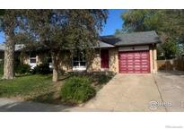 Charming single-story brick home with a well-maintained front yard and an attached red two-car garage at 12820 Dexter St, Thornton, CO 80241