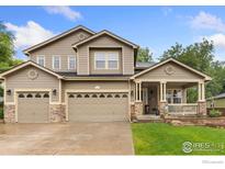 Charming two-story home with a three-car garage and a cozy front porch at 1831 Ashford Cir, Longmont, CO 80504