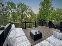 Relaxing back deck with comfortable seating and an elegant table, perfect for enjoying the outdoors at 2248 Imperial Ln, Superior, CO 80027