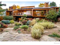 Stunning two-story home with a unique design, beautiful landscaping, and a large balcony perfect for outdoor living at 3746 Wonderland Hill Ave, Boulder, CO 80304