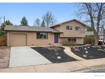 Charming home featuring a manicured front yard, brick accents, and an attached garage at 4035 Darley Ave, Boulder, CO 80305