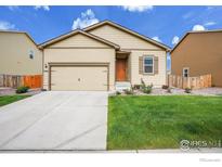 Charming single-story home featuring an attached garage, landscaped front yard, and inviting curb appeal at 7306 Ellingwood Cir, Frederick, CO 80504