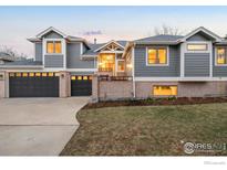 Attractive two-story home with gray siding, a three-car garage, and well-maintained landscaping at 990 Utica Cir, Boulder, CO 80304