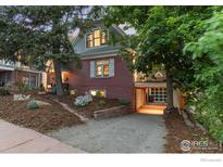 Charming two-story home featuring brick facade, garden, and unique drive-under garage at 1133 Mapleton Ave, Boulder, CO 80304