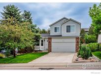 Charming two-story home featuring a brick facade and a well-manicured front yard at 2940 E Yarrow Cir, Superior, CO 80027