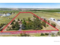 A residence with land delineated by approximate property lines, set against a backdrop of fields and distant mountains at 2965 Wagner St, Strasburg, CO 80136