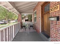 Inviting front porch with seating area, brick columns, and views of the street at 3039 W Denver Pl, Denver, CO 80211