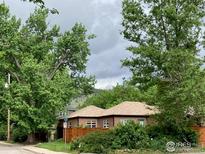 Charming brick home nestled amidst lush greenery and mature trees in a desirable neighborhood at 3201 Broadway St, Boulder, CO 80304