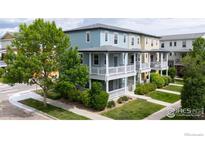 Charming two-story townhomes with inviting front porches and well-manicured lawns at 705 Rawlins Way, Lafayette, CO 80026