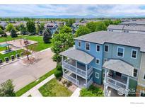 Charming townhome boasts a double balcony and is located across from the community playground and green space at 705 Rawlins Way, Lafayette, CO 80026