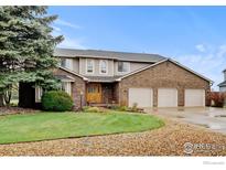 Charming two-story home with a well-manicured lawn, mature trees and three-car garage at 7505 Estate Cir, Niwot, CO 80503