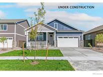 Charming blue two-story home with a covered porch, well-manicured lawn, and two-car garage at 9940 Biscay St, Commerce City, CO 80022