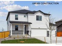 Charming two-story home with white siding, black accents, covered porch, and a two-car garage at 13802 Quartz St, Mead, CO 80504